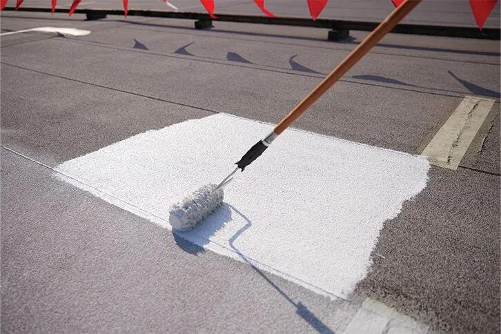 Coating being rolled over a granulated asphaltic roof